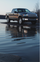 Truck next to water.