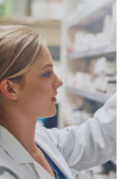 Pharmacist looking on a shelf.