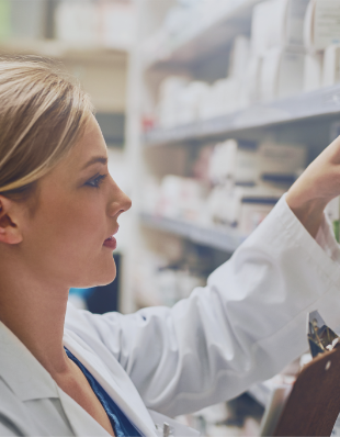 Pharmacist looking on a shelf.