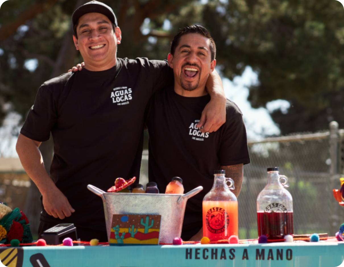 Business owners smiling and posing for the camera.