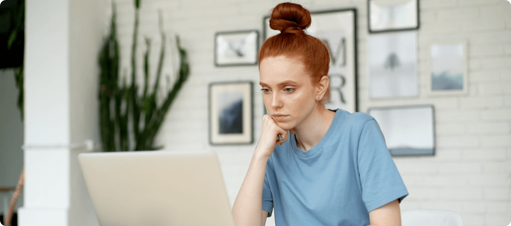 Woman thinking at computer.