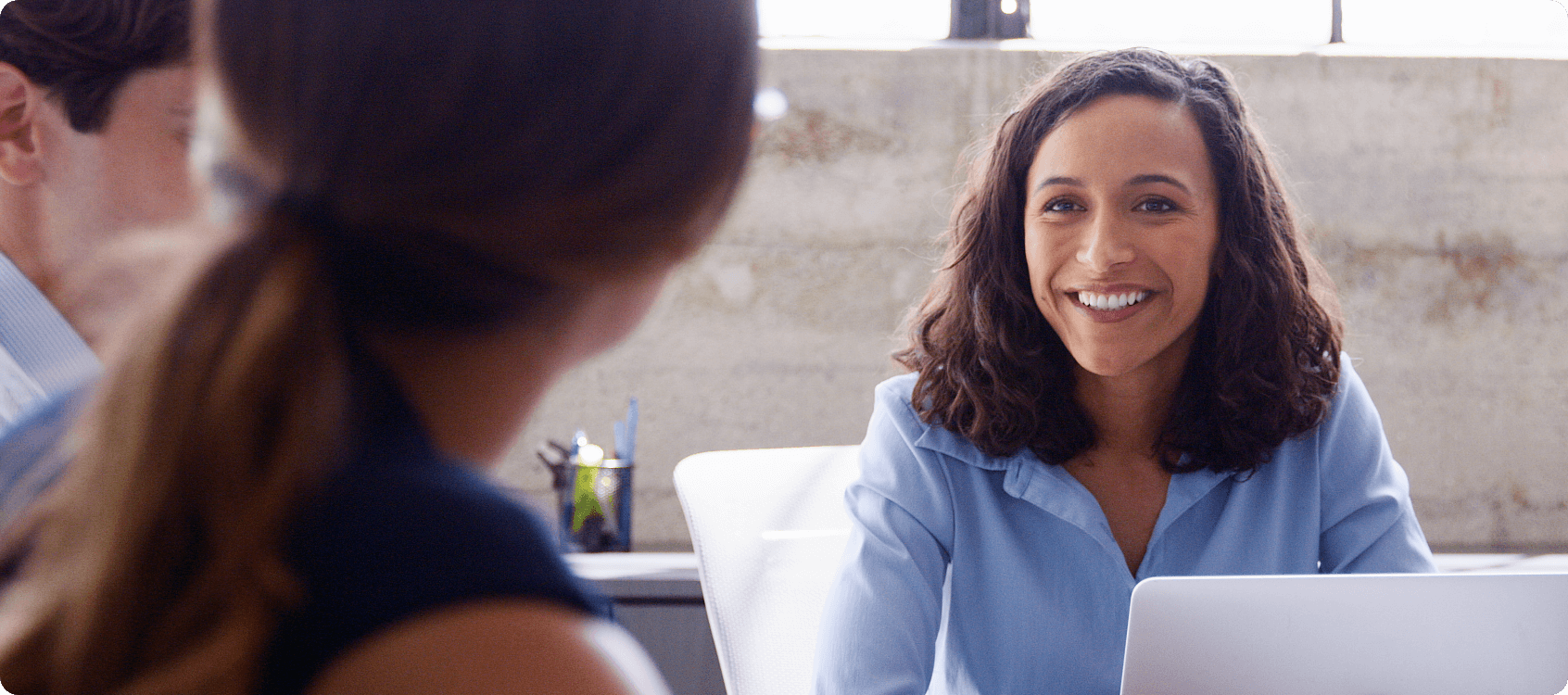 Woman smiling in meeting.