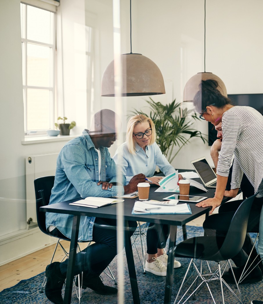 Various people at a table having a meeting.