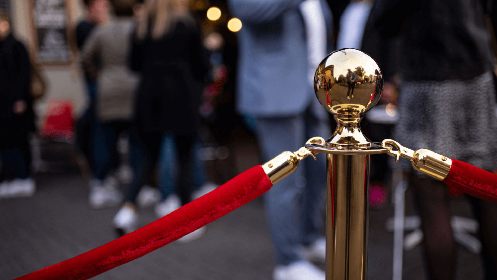 Image focused on the velvet rope and connector at an event.