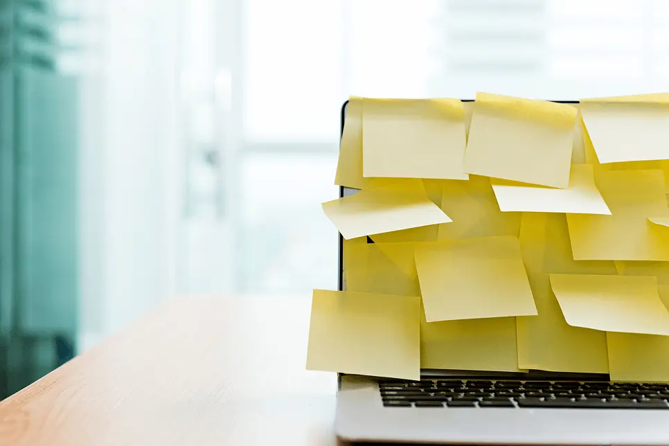 Image of a laptop with the screen completely covered with blank post it notes.